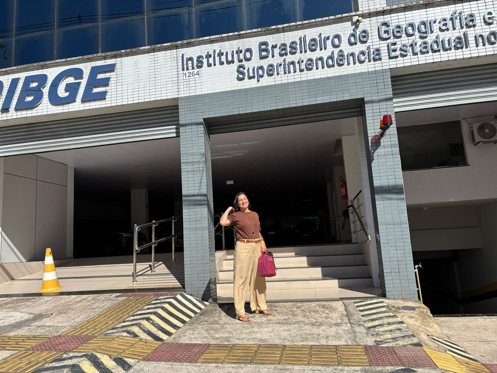 A person standing in front of a building

Description automatically generated